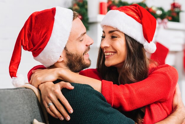 Happy couple smiling on sofa