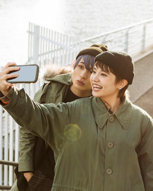 Free photo happy couple taking selfie medium shot