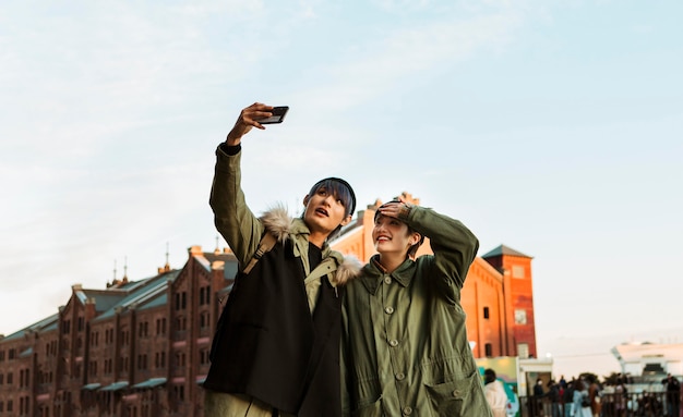 Happy couple taking selfie medium shot