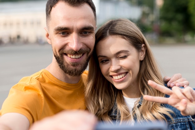 Free photo happy couple taking a selfie