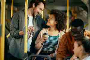 Free photo happy couple talking while commuting by bus