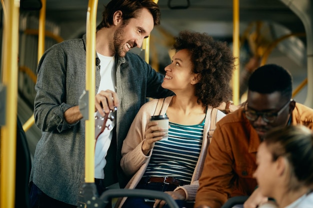 Happy couple talking while commuting by bus