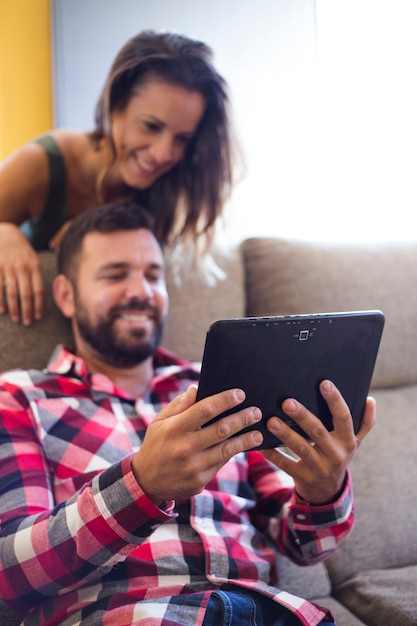 Free photo happy couple using digital tablet at home