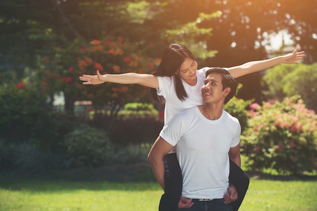 Happy couple on vacation enjoy each other in the park