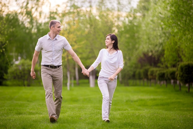 Happy couple walking in park