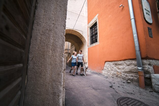 Happy couple walking with their pet