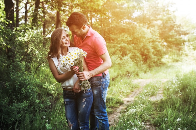 Happy couple with a bouquet of daisies