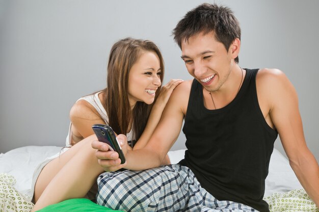 Happy couple with mobile phone