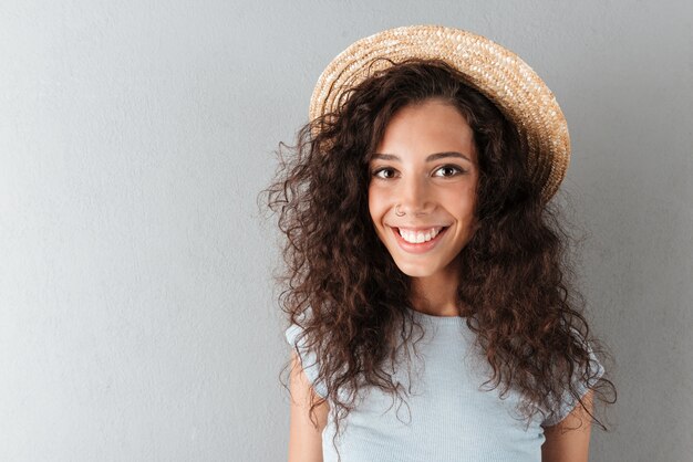Free photo happy curly woman in hat