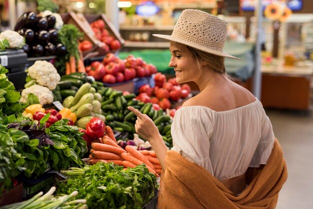 happy customer looking at veggies