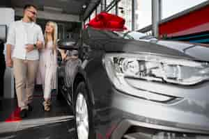 Free photo happy customers in car dealership