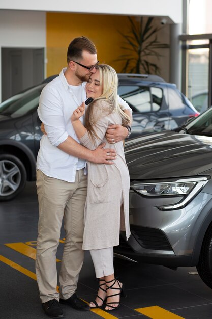 Happy customers in car dealership