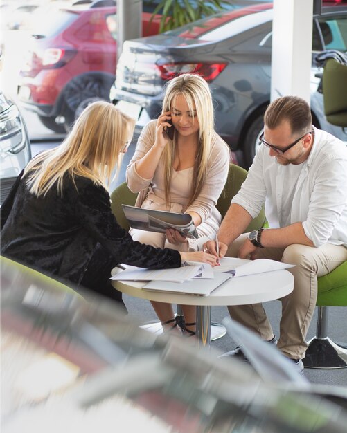 Happy customers in car dealership