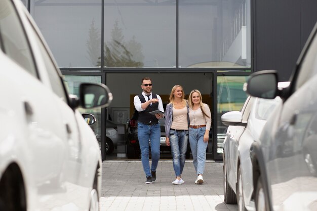 Happy customers in car dealership