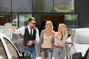 Free photo happy customers in car dealership