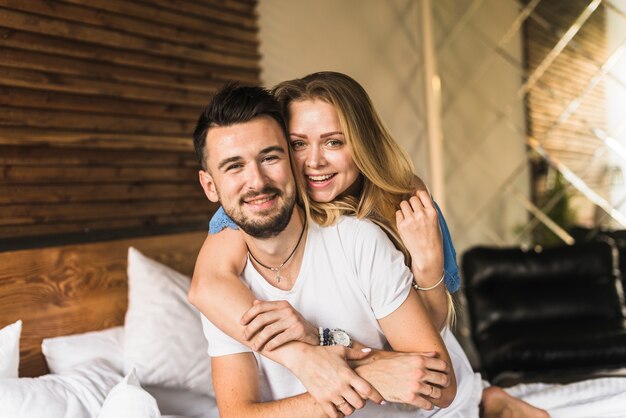 Happy cute couple on bed