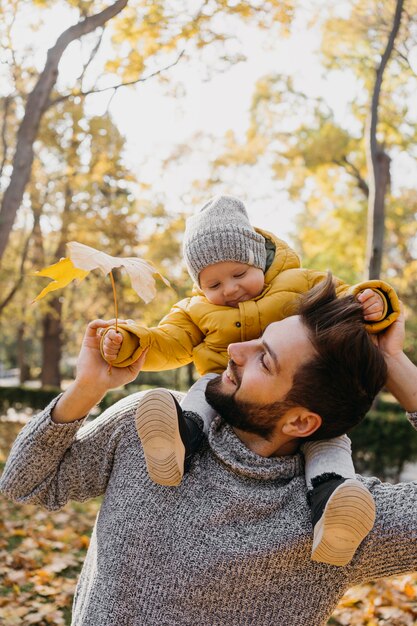 Happy dad with his baby outdoors