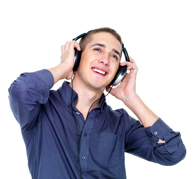 Happy dancing man with headphones looking up - isolated on 