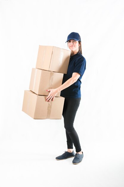 Happy delivery woman holding stacked of parcel