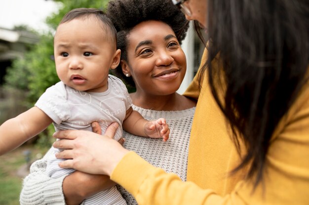 Happy diverse family standing in front of their house during lockdown