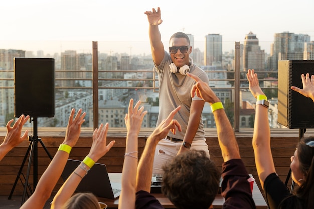 Happy dj on rooftop front view