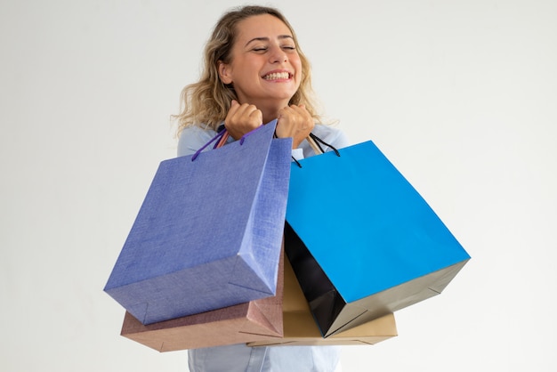 Happy dreamy lady making wish while going shopping