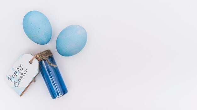 Happy Easter inscription with blue eggs