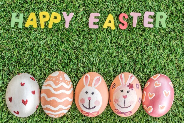 happy easter word spelling on grass background