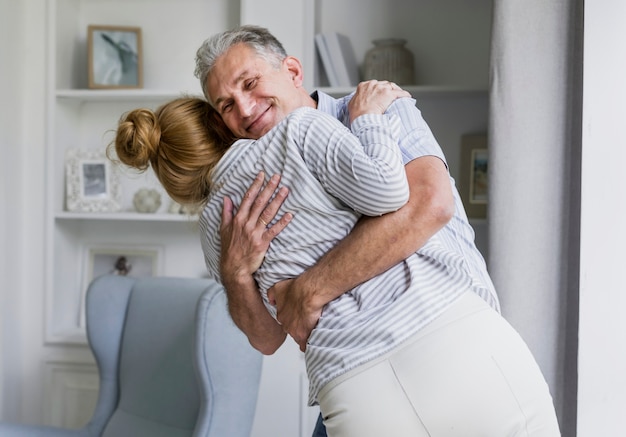 Happy elderly couple hugging each other