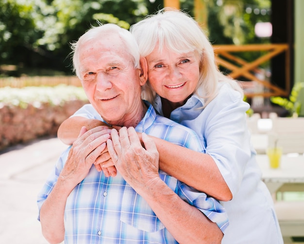 Happy elderly couple looking at camera