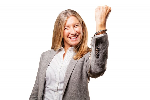 Happy elderly woman handcuffed