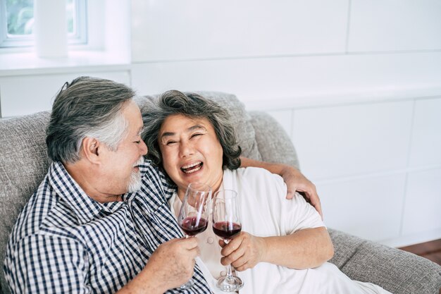 Happy Elderly woman and her husband drinking wine and happiness