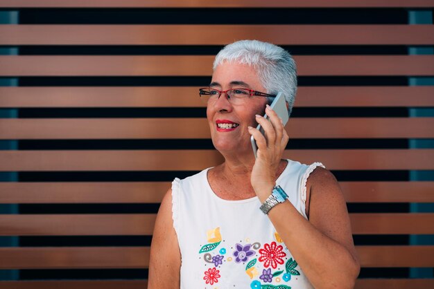 Happy elderly woman on the mobile phone