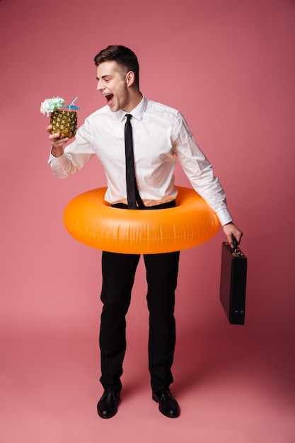 Happy emotional young businessman with rubber ring.