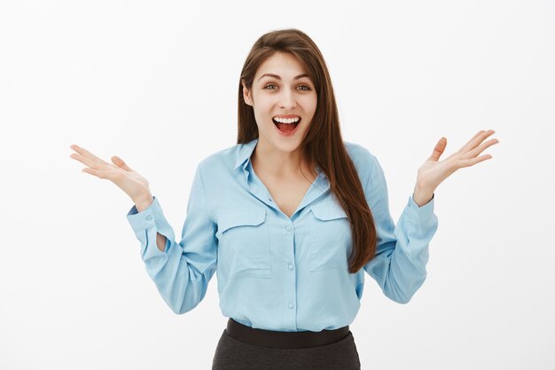 happy emotive brunette businesswoman posing in the studio