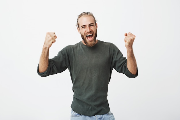 Happy enthusiastic bearded dad with stylish clothes screaming