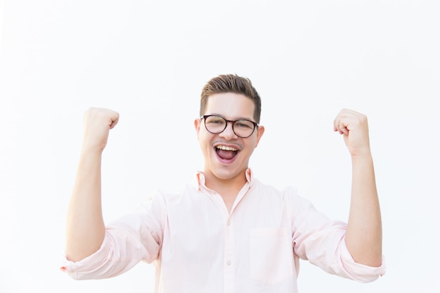 Happy excited guy in eyeglasses shouting for joy