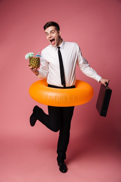 Happy excited young businessman with rubber ring