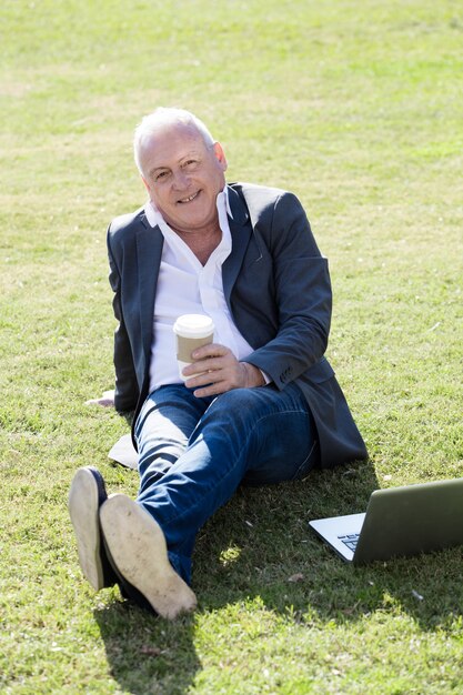 Happy executive with laptop on a sunny day