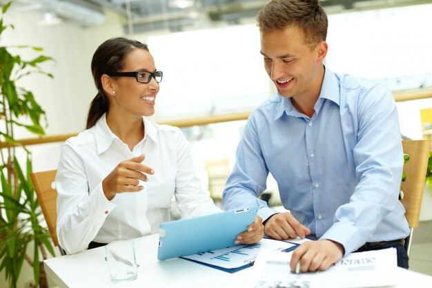 Happy executives working with a tablet