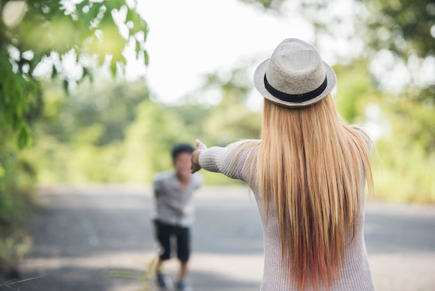 Happy family concept. Rear of mother playing with her little son together in a park. 