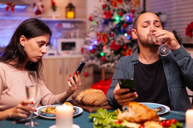 Happy family eating delicious dinner sitting at dining table