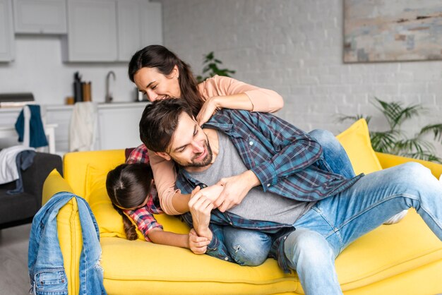 Happy family fooling around in living room