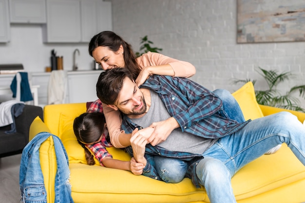 Happy family fooling around in living room