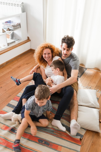 Free photo happy family having fun on rug