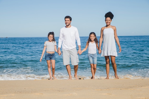 Happy family holding hands