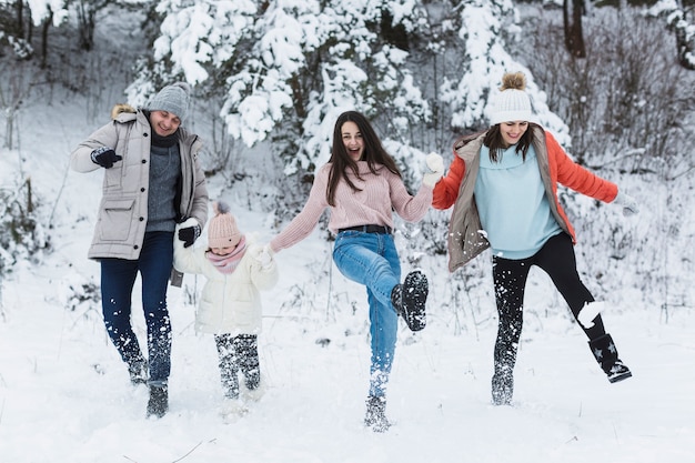 Happy family kicking snow