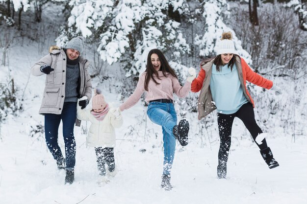 Happy family kicking snow