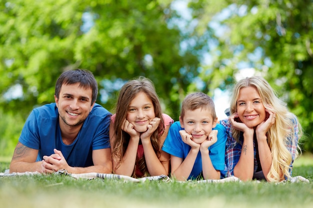 Happy family lying in a row