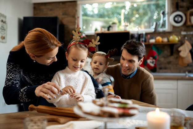Happy family making christmas cookies in the kitchen